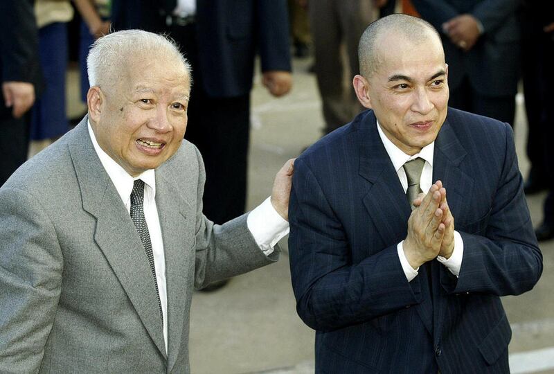 FILE - In this Oct. 20, 2004 file photo, Cambodia's King Norodom Sihanouk, left, introduces his son and successor, King Norodom Sihamoni upon their arrival at Phnom Penh airport, in Cambodia. Sihanouk, the former Cambodian king who was never far from the