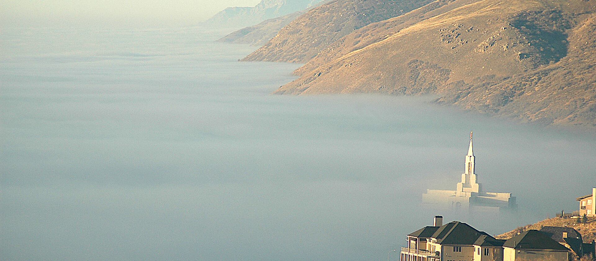 The Bountiful Utah Temple pokes through the fog as it envelops the valleys along the Wasatch Front in 2004.