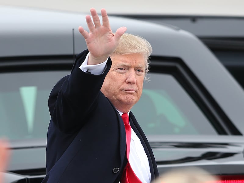 President Donald Trump waves to the crowd at Roland R. Wright Air National Guard Base at the Salt Lake City International Airport.