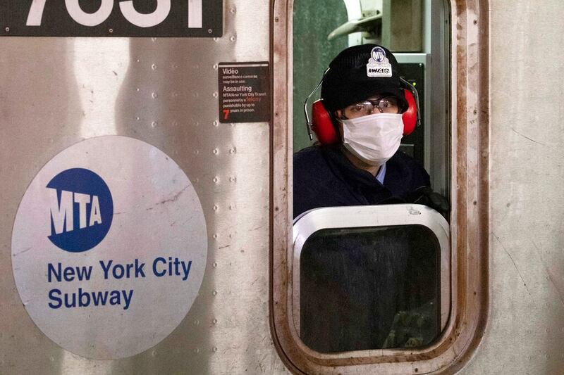 A subway conductor wears a face mask in the Bronx borough of New York.