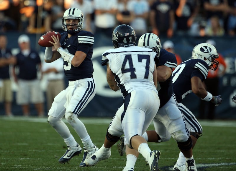 BYU quarterback Jake Heaps, left, drops back against Nevada at LaVell Edwards Stadium in Provo on Sept. 25, 2010. BYU lost 27-13.