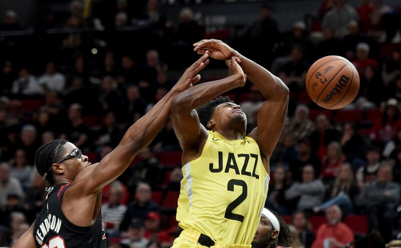 Utah Jazz guard Collin Sexton, right, is fouled by Portland Trail Blazers guard Scoot Hendersonas on a drive to the basket during the second half of an NBA basketball game in Portland, Ore., Wednesday, Nov. 22, 2023. (AP Photo/Steve Dykes)
