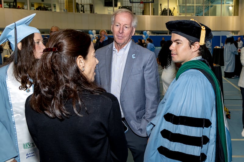 Columbia University athletic director Peter Pilling visits with Columbia graduate.