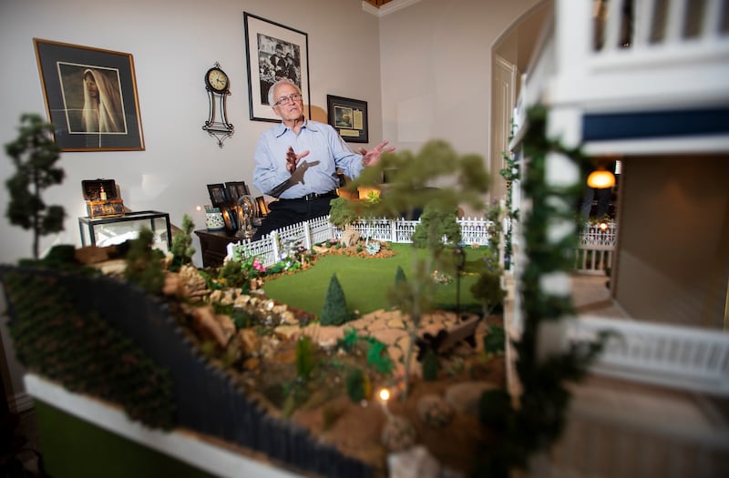 Larry Elkins shows a dollhouse he built matching the dream home he and his late wife Linda had planned to build as he talks about their life together and their family on Wednesday, March 27, 2019.