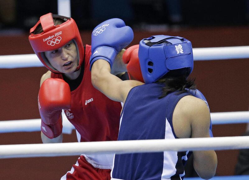 Ireland's Katie Taylor, left, fights Tajikistan's Mavzuna Chorieva in a lightweight 60-kg semifinal boxing match at the 2012 Summer Olympics, Wednesday, Aug. 8, 2012, in London.