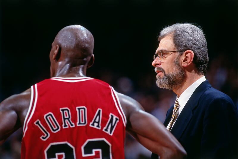 MIAMI - APRIL 2: Michael Jordan #23 and Phil Jackson of the Chicago Bulls look on against the Miami Heat on April 2, 1996 at Miami Arena in Miami, Florida. NOTE TO USER: User expressly acknowledges and agrees that, by downloading and or using this photograph, User is consenting to the terms and conditions of the Getty Images License Agreement. Mandatory Copyright Notice: Copyright 1996 NBAE (Photo by Andrew D. Bernstein/NBAE via Getty Images)