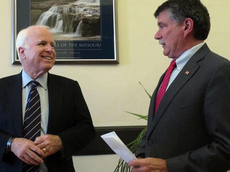U.S. Sen. John McCain, left, reacts to U.S. Rep. Denny Rehberg on Friday, Aug. 17, 2012, while campaigning for Rehberg in Great Falls, Mont. Rehberg is enlisting McCain's help as he attempts to woo veterans in his race to unseat U.S. Sen. Jon Tester.