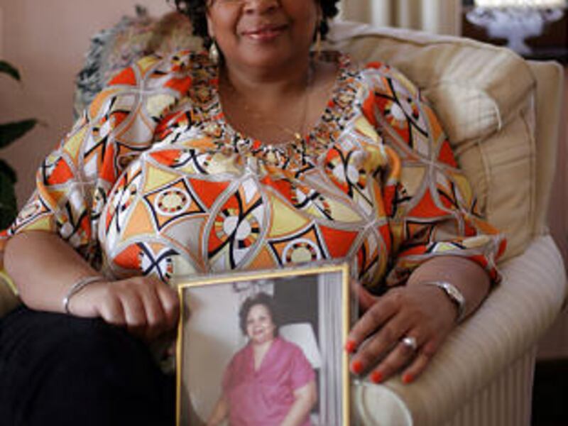 LaDonna Dean, of Detroit, Michigan, holds a year 2000 photo of her mother, Geraldine Brooks, on Friday, April 17, 2009. The chair she is sitting in belong to her deceased mother.