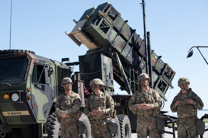 Members of U.S. 10th Army Air and Missile Defense Command stand next to a Patriot surface-to-air missile battery at the Siauliai airbase in Lithuania.