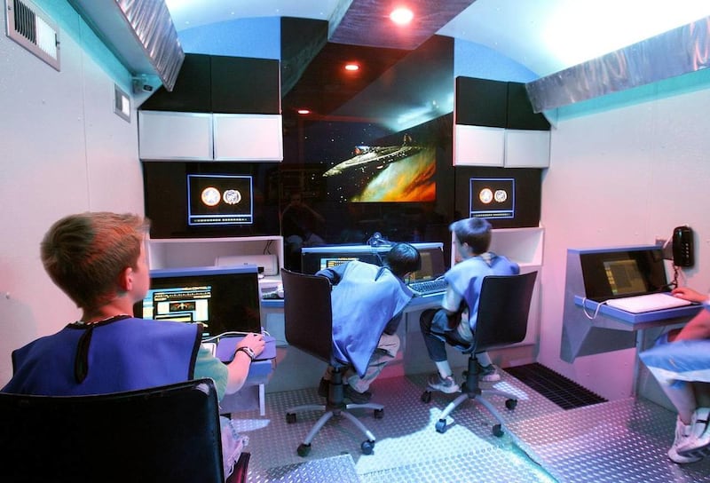 A group of 11-year-old boys sit at their stations during a mission in the Phoenix simulator at the Christa McAuliffe Space Center in Pleasant Grove.