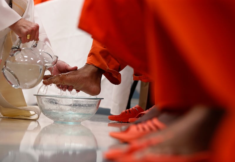 New Orleans Archbishop Gregory Aymond washes the feet of inmates during a Holy Thursday prayer service at the Orleans Justice Center in New Orleans, Thursday, April 13, 2017. 
