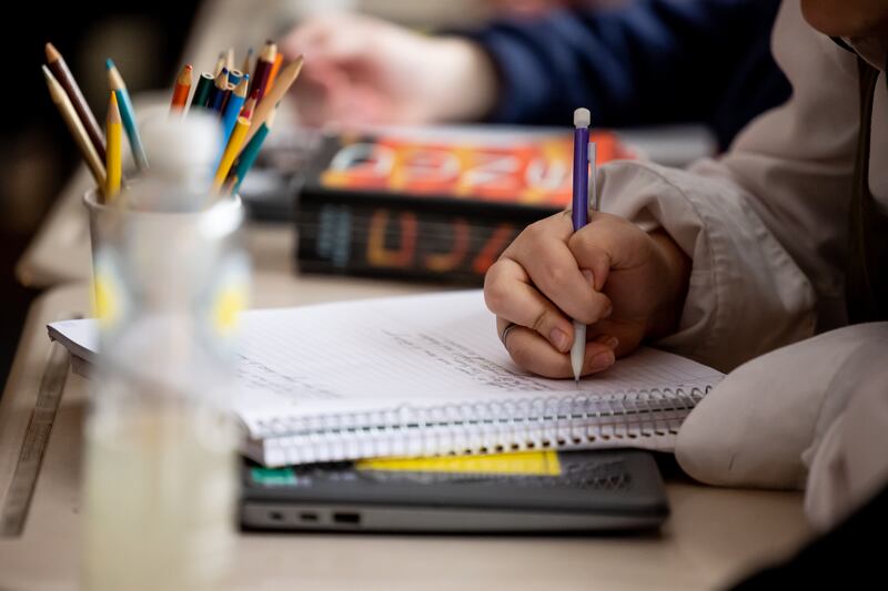 A student takes notes during an English class at Cyprus High School in Magna on Friday, Jan. 27, 2023.
