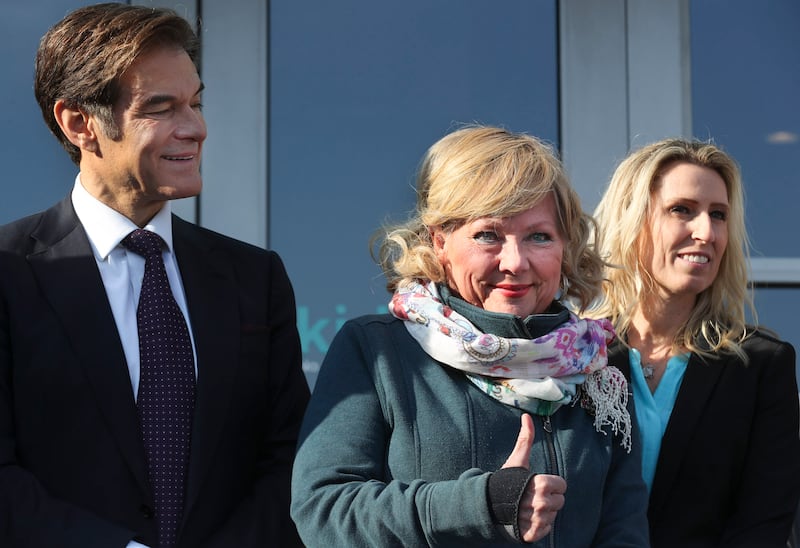 Lynda Brown, founder of Kids Eat, gives a thumbs-up as she is joined by Dr. Mehmet Oz, Michelle Benedict, founder of Kids Next Door, and other dignitaries as USANA Kids Eat food-packing facility opens in West Valley City on Thursday, Dec. 19, 2019. To try to eliminate the issue of 1 in 5 Utah kids going home to no food, the organization will pack 1,000 backpacks with food for seven meals in them each week for distribution to 56,000 children in Utah.