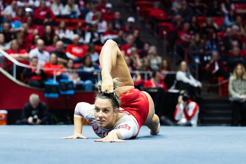 Utah’s Jaylene Gilstrap, wearing red, performs her floor routine