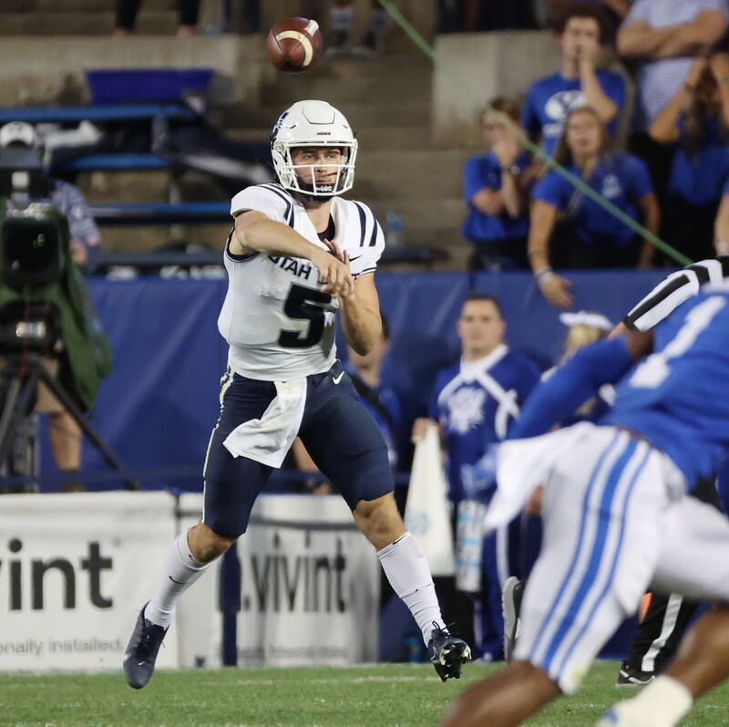 Utah State Aggies quarterback Cooper Legas (5) throws against BYU in Provo on Thursday, Sept. 29, 2022.
