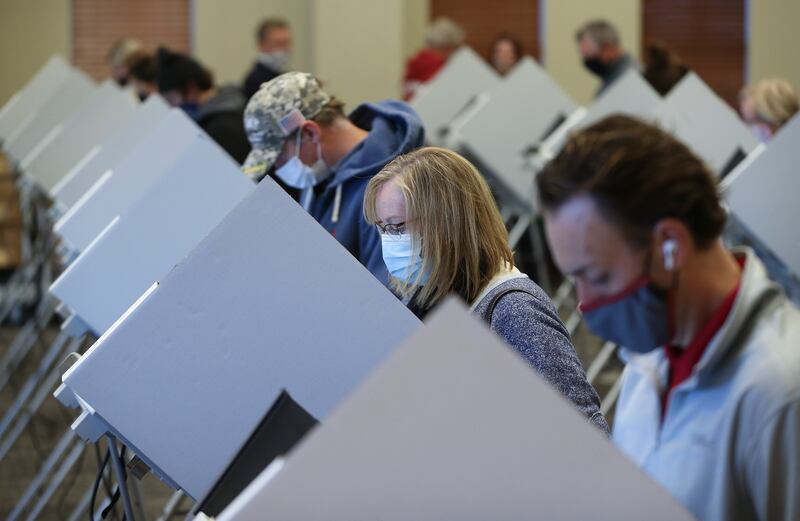 Jeanna Henderson, second from right, votes at Draper City Hall in Draper on Nov. 3, 2020.
