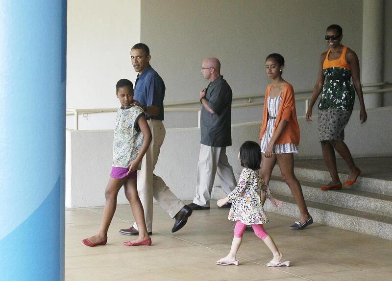 President Barack Obama and the first family leave the East-West Center after visiting an exhibit about the President's mother's anthropological work in Honolulu, Hawaii Sunday, Jan. 1, 2012.