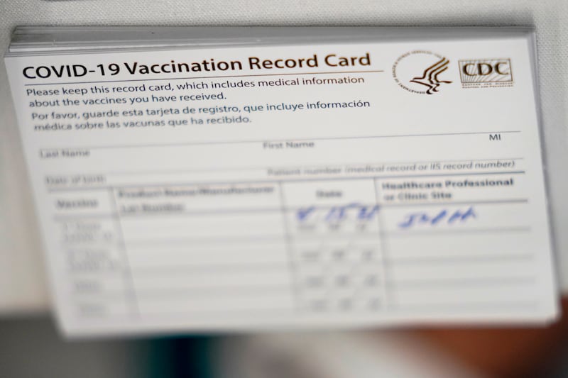 A stack of COVID-19 vaccination record cards are shown at the Christine E. Lynn Rehabilitation Center in Jackson Memorial hospital on April 15, 2021, in Miami.