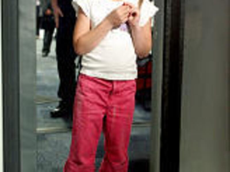 Kaylie Payne, 6, walks through the "puffer" at the Salt Lake City International Airport.