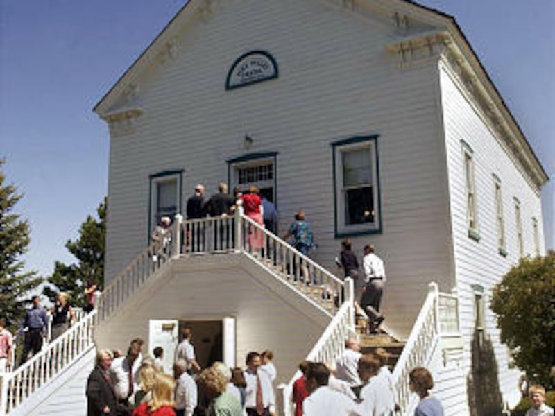 Worshippers exit the Pine Valley Chapel following the Memorial Day weekend service Sunday May 25, 2003. The tiny branch which doesn't even have regular primary classes hosts up to 700 individuals over Memorial Day weekend. The Pine Valley Chapel was bui