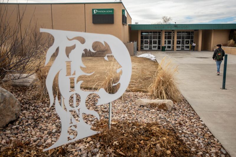 A student walks into Payson High School.