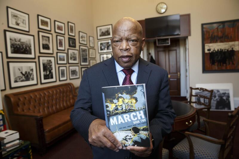 Rep. John Lewis, D-Ga., holds an installment of his award-winning graphic novel "March" on Jan. 15, 2015. The New York Times recently announced a move to eliminate its Graphic Bestseller list, a decision vexing many authors like Lewis who believe in the i