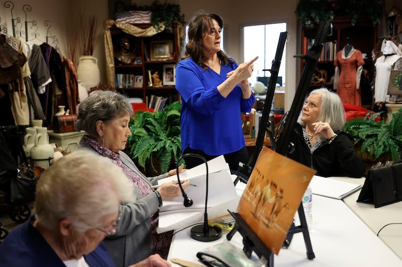 Liz Lemon Swindle teaches an art class to Pat Stevenson, left, Hi McNaughtan and Cheryl Rowley, right, in her studio in Provo, Utah.