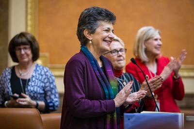 FILE - Rep. Patrice Arent, D-Salt Lake City, stands up and claps during a special session of the Utah State Legislature at the state Capitol in Salt Lake City on Monday, Dec. 3, 2018.