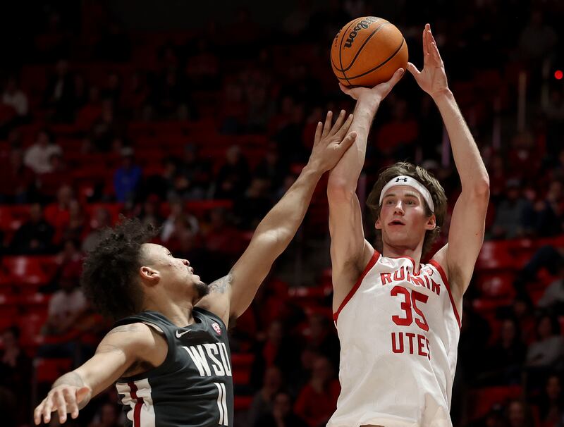 Utah center Branden Carlson gets off a shot against Washington State forward DJ Rodman at the Huntsman Center.
