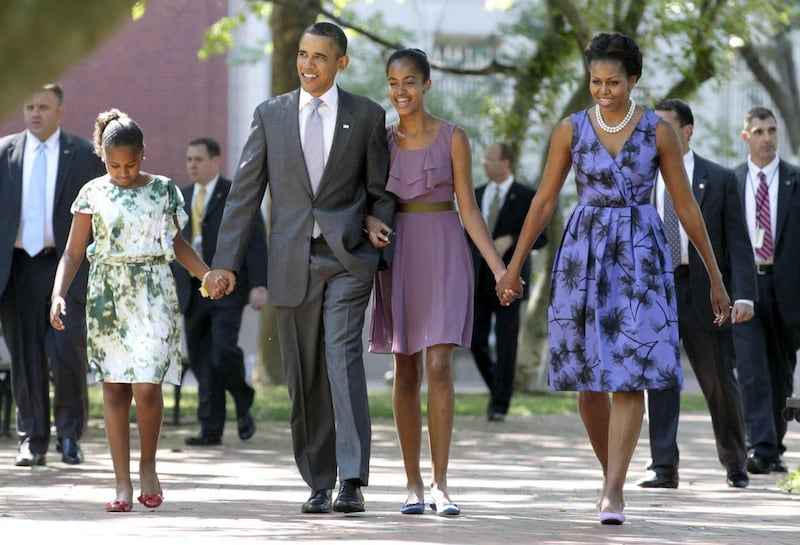 July 2011, President Barack Obama walks with his family, first lady Michelle Obama and their daughters Malia and Sasha, left, to St. John's Church, in Washington. The Obama family works hard to make sure the family comes first.