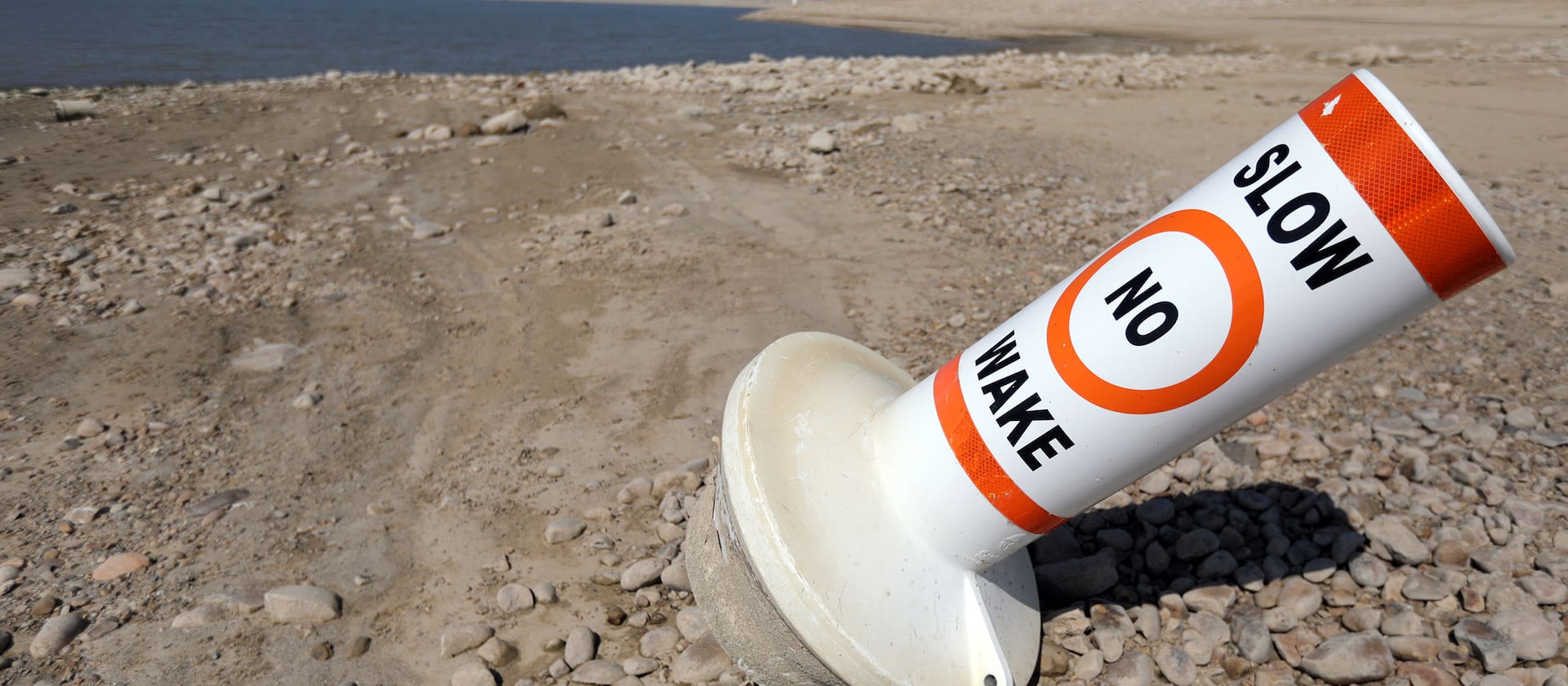 A marker buoy is grounded on the dried-up shore of Echo Reservoir on Sept. 16, 2021.