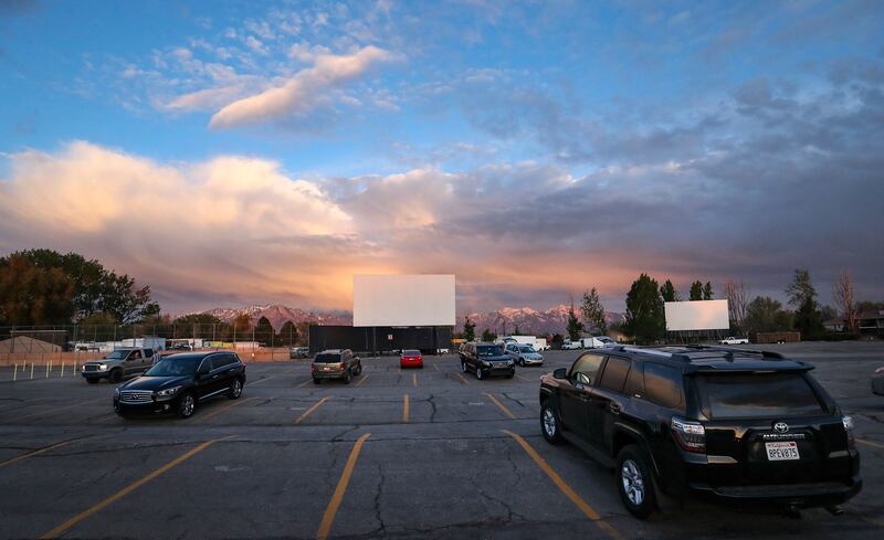 Moviegoers park their cars with at least two open spaces between each vehicle at the Redwood Drive-In Theatre in West Valley City on Friday, May 1, 2020. The drive-in was closed because of the COVID-19 pandemic but has recently reopened.