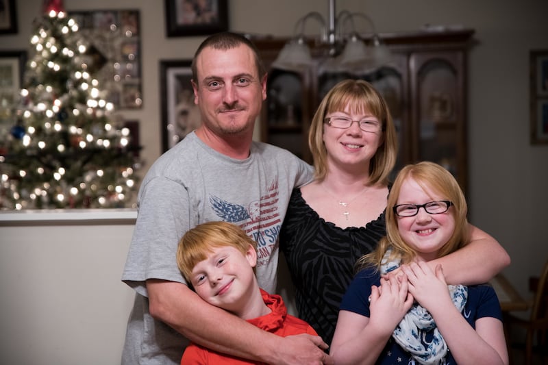 Veronica Banton poses fro a photo with her daughter, Sara, right, son, Chris, and husband, Richard, in their home Thursday, Nov. 15, 2018 in Lexington, S.C.