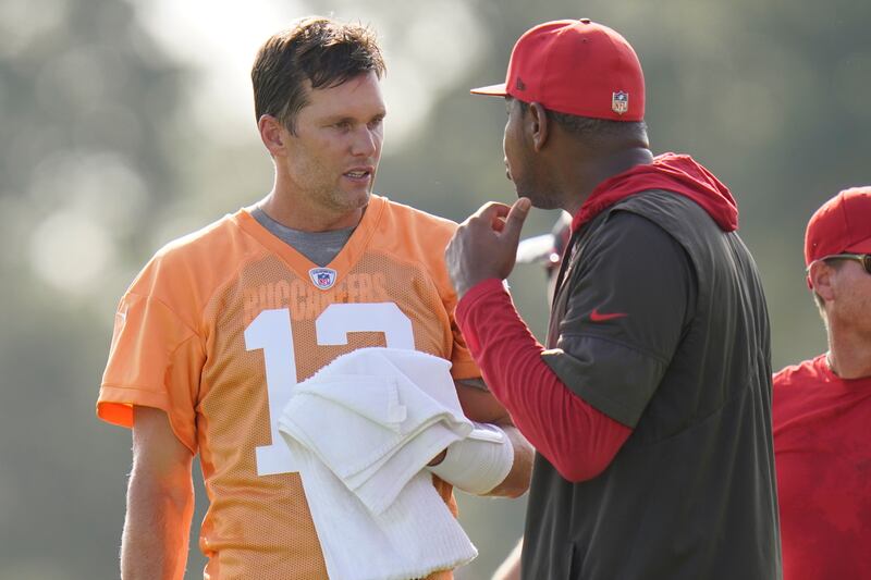 Tampa Bay Buccaneers quarterback Tom Brady talks to offensive coordinator Byron Leftwich during a training camp practice Thursday, July 28, 2022.