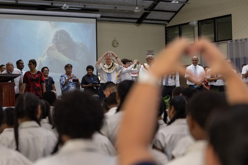 Elder David A. Bednar of the Quorum of the Twelve Apostles makes a heart sign during a devotional in Suva, Fiji. The Bednars ministered in four nations in the Pacific Area May 15-25, 2025.