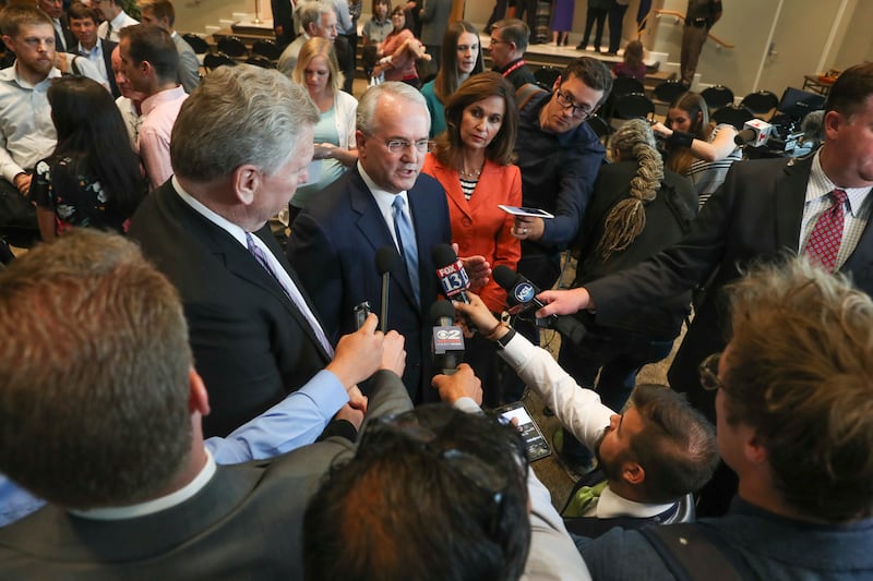Elder Jack Gerard, a General Authority Seventy of The Church of Jesus Christ of Latter-day Saints, center, talks with members of the media after a broad coalition of Utah community leaders announced its opposition to Utah's medical marijuana ballot initia