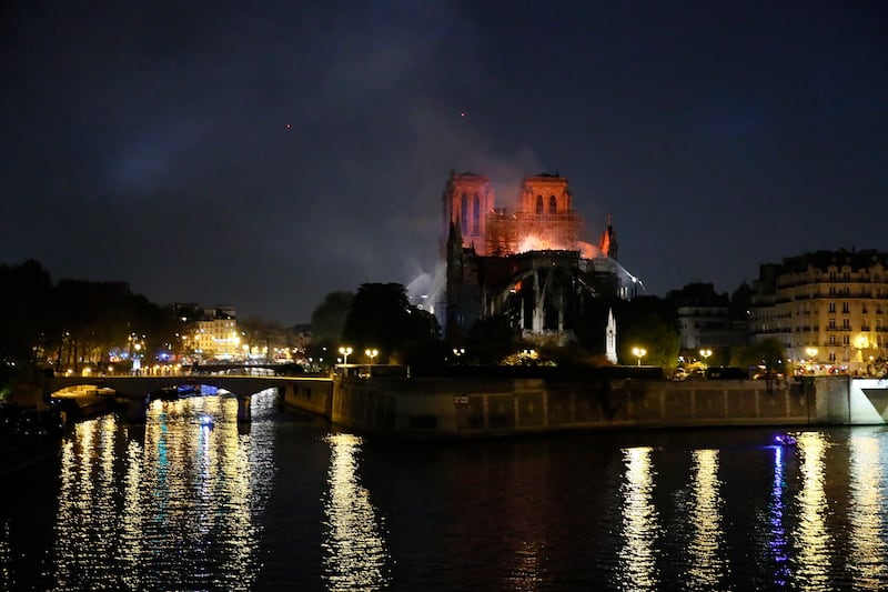 Notre Dame cathedral is seen burning in Paris, Monday, April 15, 2019. A catastrophic fire engulfed the upper reaches of Paris' soaring Notre Dame Cathedral as it was undergoing renovations Monday, threatening one of the greatest architectural treasures o
