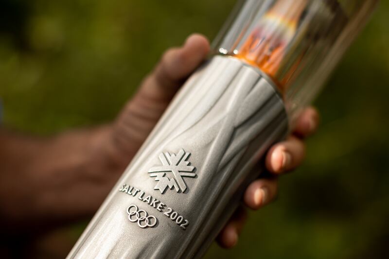 Fraser Bullock holds an Olympic torch from the 2002 Winter Games.
