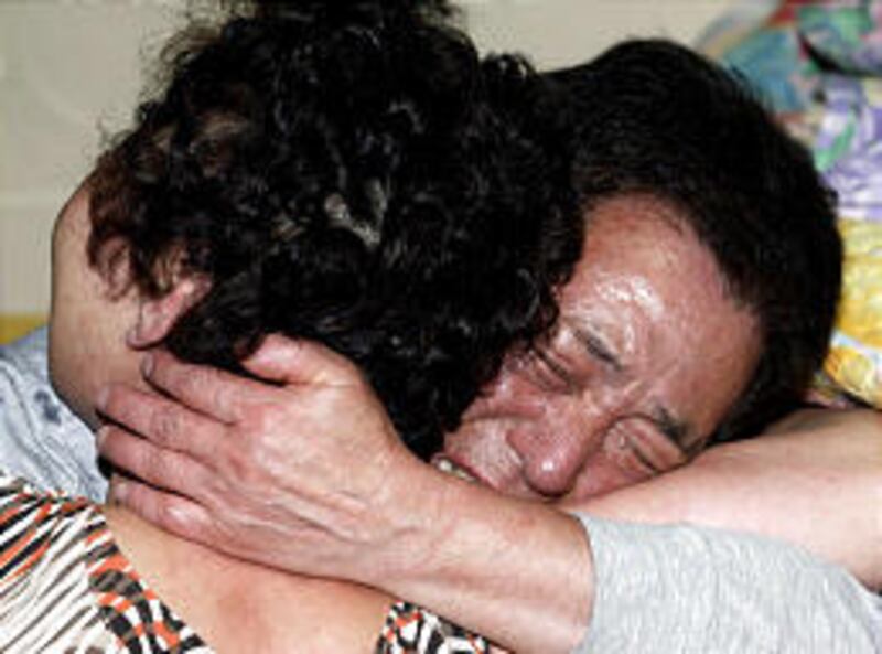 Shin Young-Ja, left, and Kim Jong-Kyu grieve in Busan, South Korea, after hearing that their son, Kim Sun-Il, was murdered in Iraq.