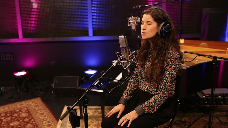 Rebecca López Peñailillo sings in a recording studio.