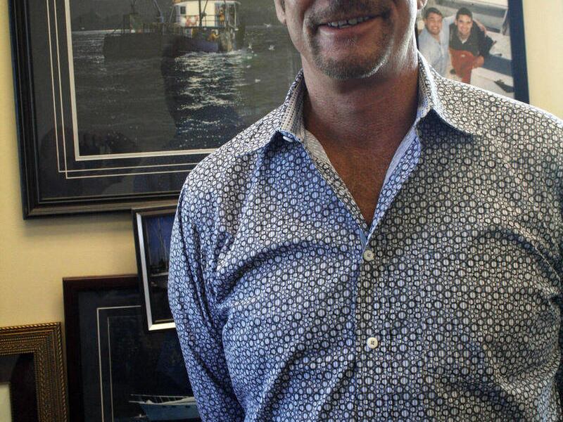 In this photo taken May 24, 2011, Tom Alexander poses for a photo in his real estate office in Anchorage, Alaska. Alexander and four others survived the sinking of a pleasure boat on Sunday, May 22, 2011, near Kodiak Island, Alaska.