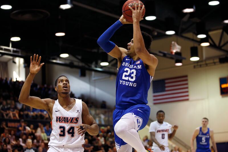 BYU forward Yoeli Childs (wearing blue) shoots against Pepperdine center Victor Ohia Obioha (34) during an NCAA college basketball game.