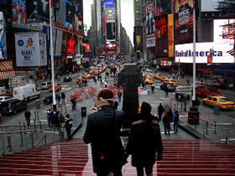 Cars and pedestrians pass along Broadway in Times Square Feb. 26 in New York City. Broadway, the world-famous thoroughfare will become a pedestrian walkway around Times Square.