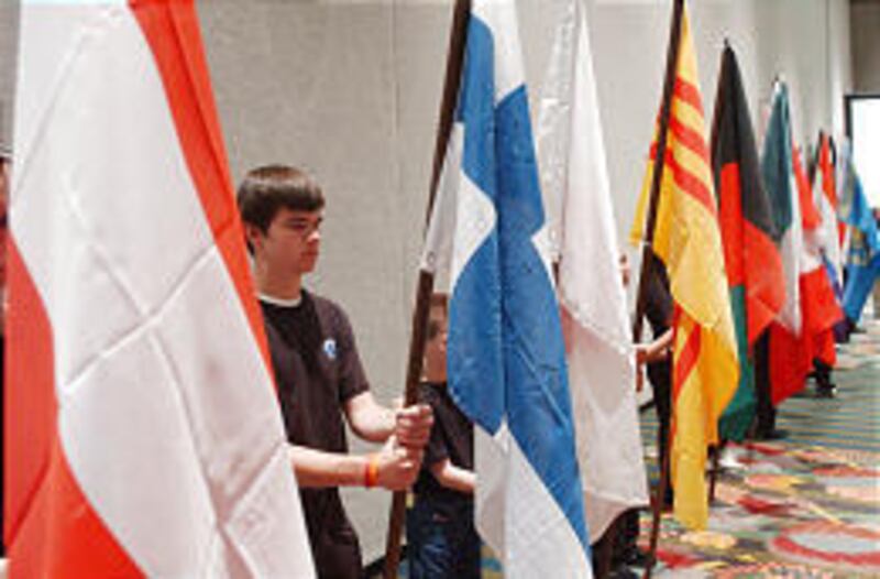 Brent Anderson holds a flag during the Association of Space Explorers' annual meeting on Monday.