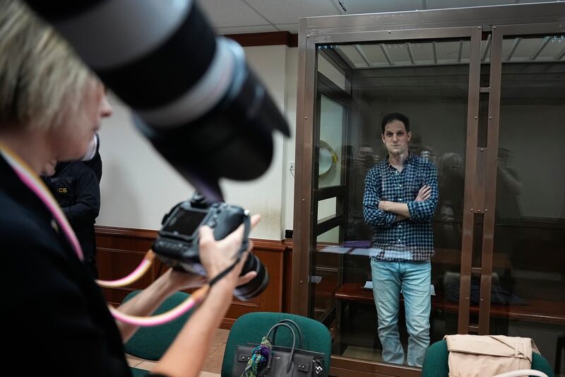 Wall Street Journal reporter Evan Gershkovich stands in a glass cage as he is photographed in a courtroom at the Moscow City Court.