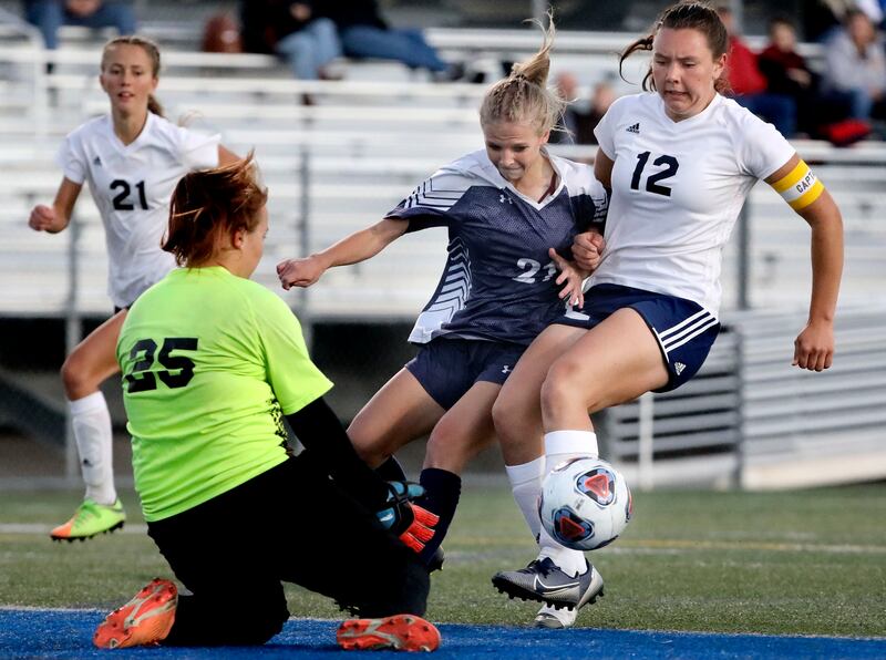 Waterford’s Grace Morris tries to score against Millard’s Lucy Freeman and Hannah Koyle in the 2A girls soccer semifinals.