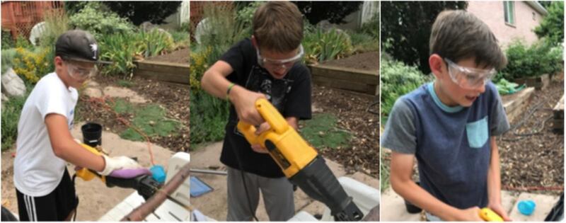 Benny, Abe and Oliver, Greg Bell's grandchildren, cut up a downed tree limb into firewood.