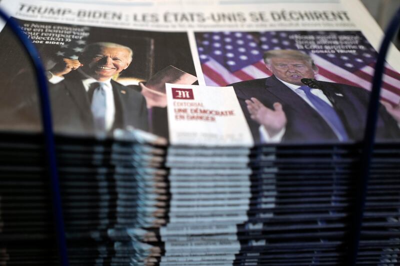 A pile of French newspaper Le Monde headlines “Trump-Biden : the United States is tearing itself apart, Editorial : a democracy in danger” about the U.S. presidential elections, at a newspapers stand in Paris, Wednesday, Nov. 4, 2020. The world is watching as millions of Americans cast their ballots for the next president on Tuesday.