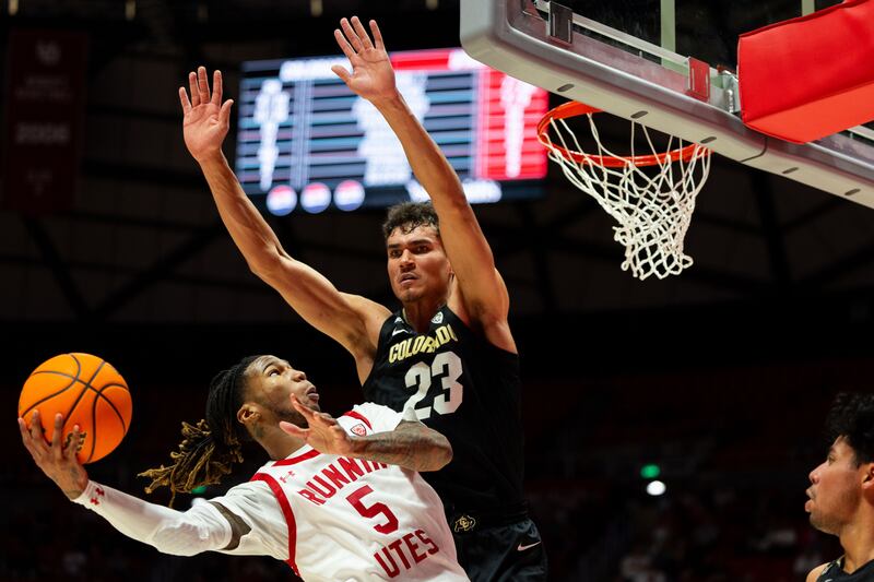 Utah Utes guard Deivon Smith (5) shoots the ball with Colorado Buffaloes forward Tristan da Silva (23) on defense.