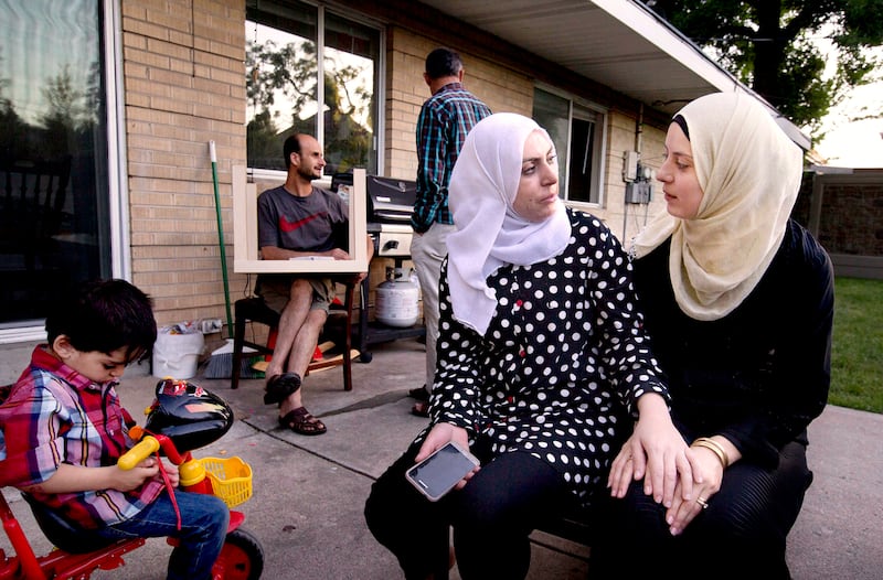 Baraa Huraideen, right, and Rasha Hredeen chat in the backyard of the Hredeens’ home in Millcreek on June 6, 2017.